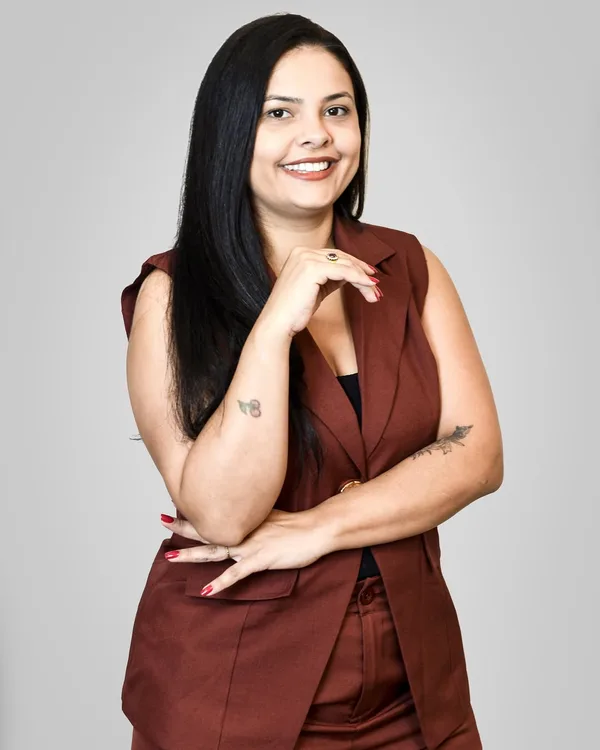 Priscila Horácio Nunes sorrindo, mão no queixo